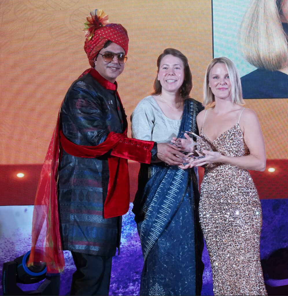Laura Krys accepting her award from Dr. Kapil Dua and Aileen Ullrich
